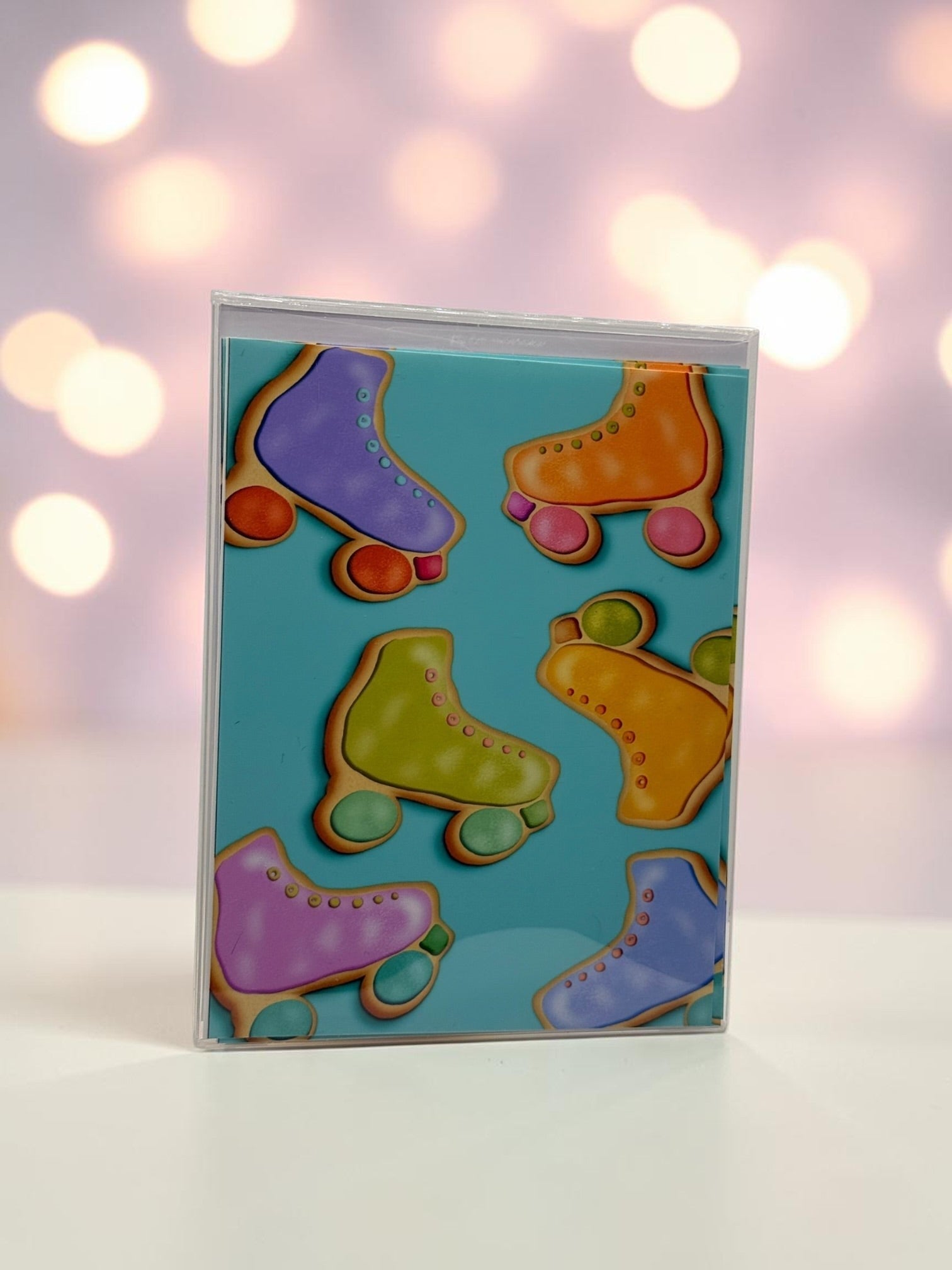 La Apau Creations card set featuring colorful retro roller skate cookie illustrations on a teal background.