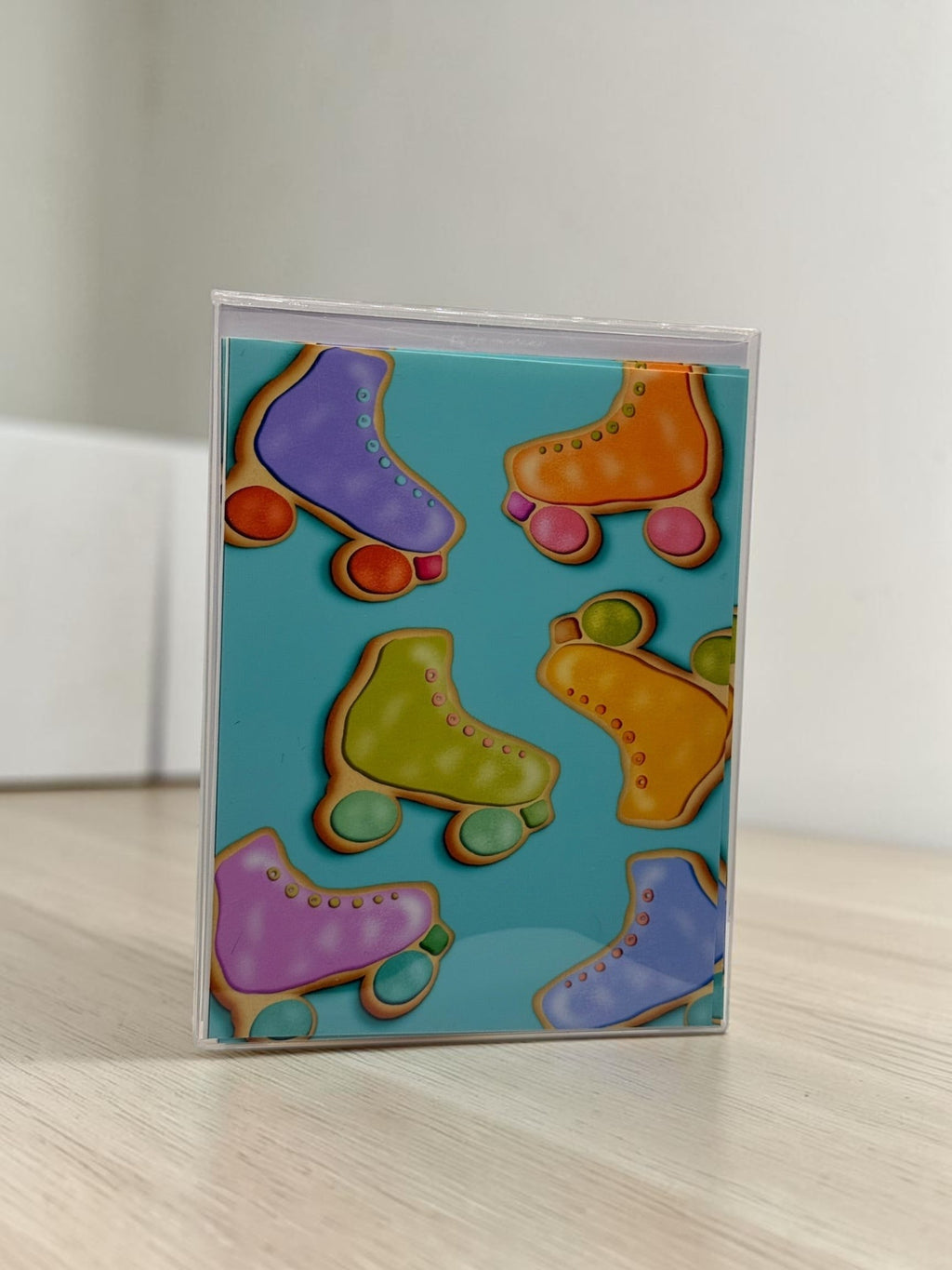 La Apau Creations card set featuring colorful retro roller skate cookie illustrations on a teal background.