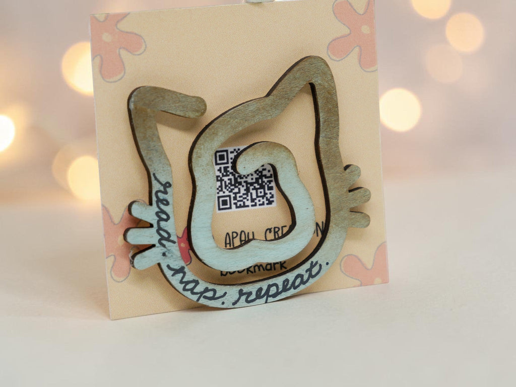La Apau Creations wooden cat bookmark with ombre brown to blue finish and read nap repeat text on display card